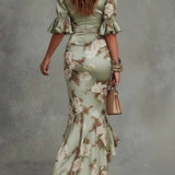 Aoife — Asymmetrical long dress in green satin with V-neck, flared puff sleeves, and floral pattern